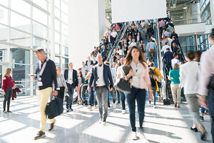 HelloWorld_FeaturedImage Indoor crowd of people going up and down an escalator